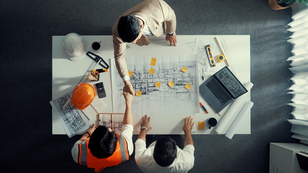 Top,Down,Aerial,View,Of,Architect,Engineer,Team,Shake,Hands